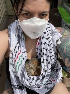 Aila with a baby squirrel in keffiyeh